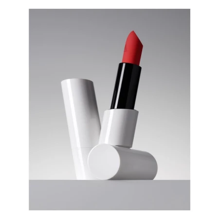 Product shot of open red lipstick tube, white packaging, and a neutral background for beauty and cosmetic product photography.