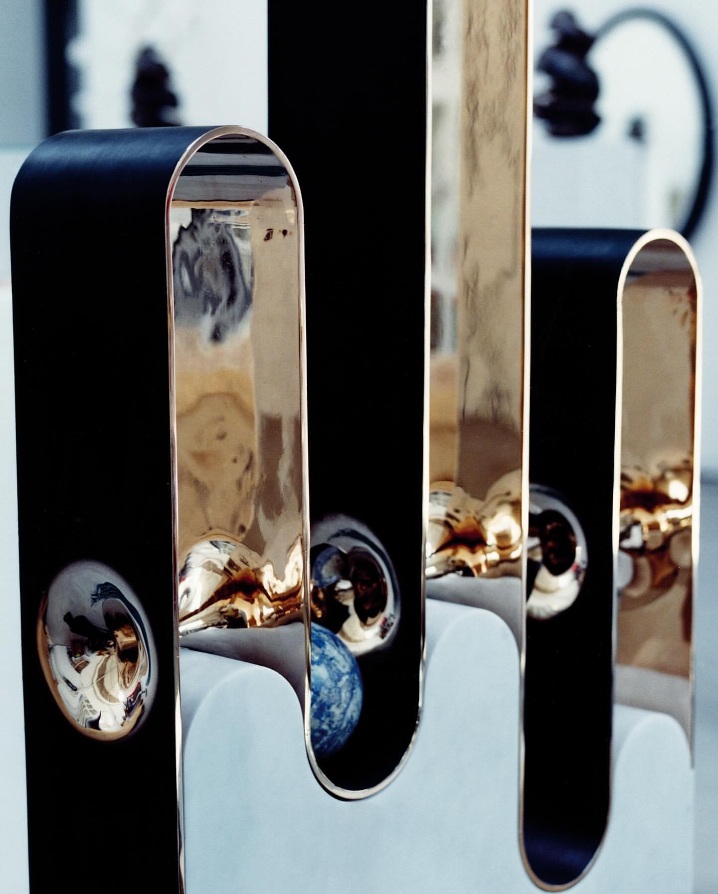 Modern abstract sculpture with metallic accents and a geometric base, creating a visually striking and contemporary artistic statement.