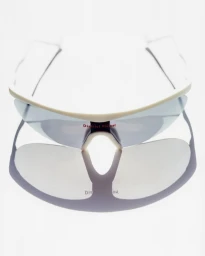 District Vision white sports sunglasses viewed from above with a crisp reflection on a clean white background