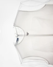 Close-up of a sheer white layered mesh garment on a clean white background, photographed in Berlin.