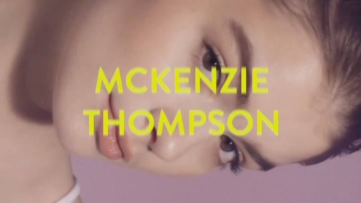 Close-up studio shot of a young woman with fair skin and neutral makeup, set against a lavender background with bright yellow text overlay.