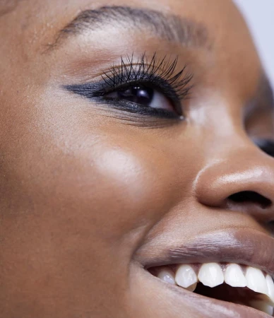 Close-up portrait of a Black woman's face highlighting winged black eyeliner and mascara by photographer Mei Tao