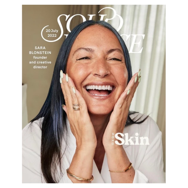 Magazine cover featuring Sara Blonstein smiling with hands on her face, promoting SOHO Skin, with visible text and a neutral background.