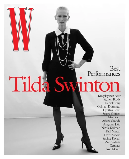 Magazine cover featuring Tilda Swinton in a black dress, pearl necklace, and heels, standing against a white background. Red W logo visible.