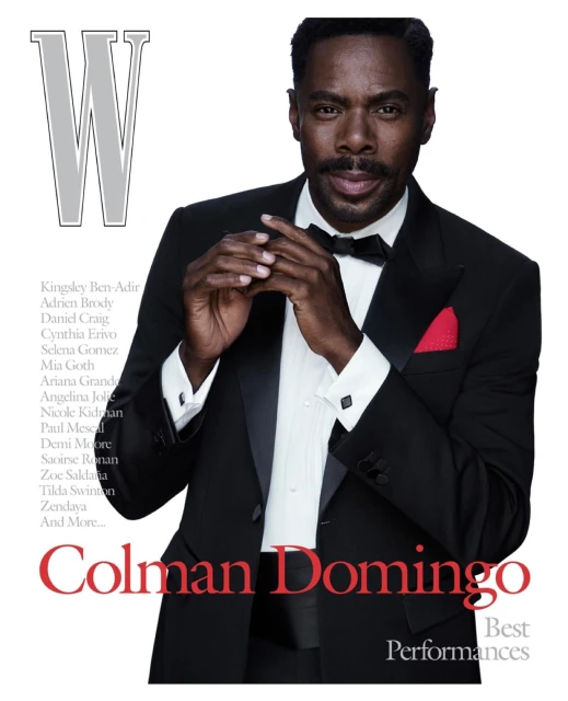 Colman Domingo on the cover of W Magazine, dressed in a classic black tuxedo with a red pocket square and a bow tie, portrait shot.