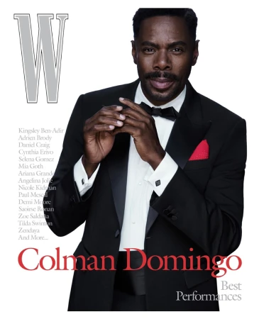 Colman Domingo on the cover of W Magazine, dressed in a classic black tuxedo with a red pocket square and a bow tie, portrait shot.