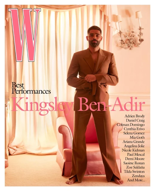 Magazine cover of Kingsley Ben-Adir wearing brown suit, standing in front of pink armchair and cream curtains. W magazine logo visible.