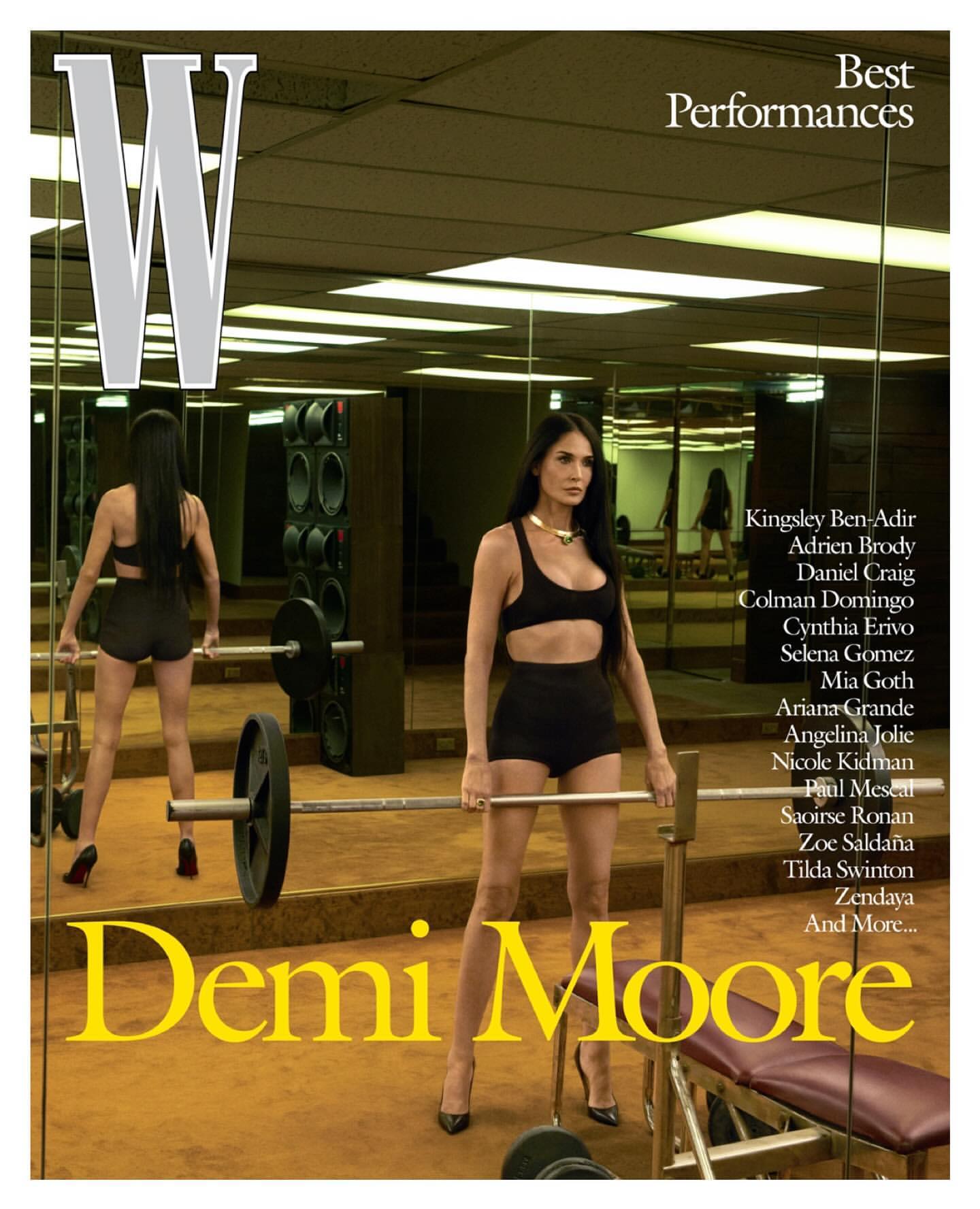 Magazine cover featuring Demi Moore in a black workout outfit lifting weights in a gym setting, with the W logo prominently displayed.
