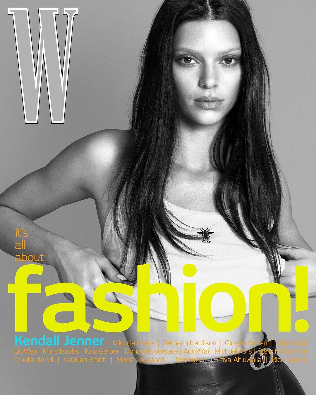 Fashion magazine cover featuring a model with long dark hair, wearing a white top and black leather skirt. 'W' logo and fashion text overlay.