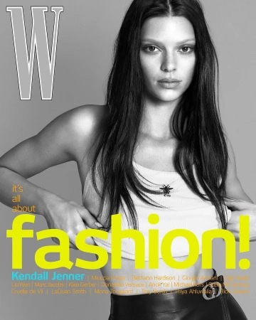 Fashion magazine cover featuring a model with long dark hair, wearing a white top and black leather skirt. 'W' logo and fashion text overlay.