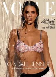 Kendall Jenner wearing a pink floral embellished bikini top under cascading water for Vogue magazine cover.