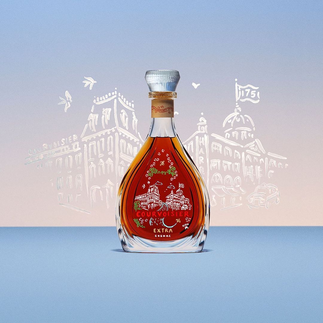 Studio shot of a Courvoisier Cognac bottle featuring a silver cap, building drawings, and light blue background, perfect for spirits and beverages.