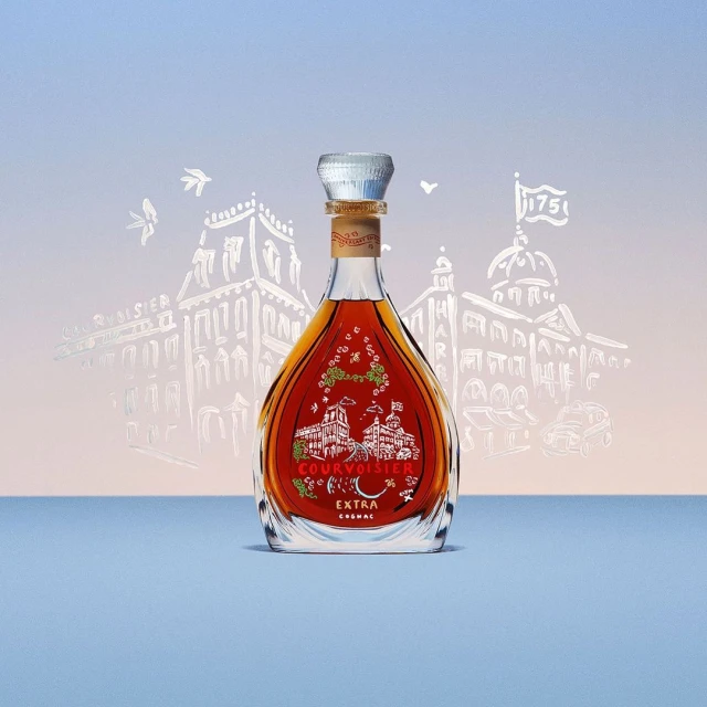 Studio shot of a Courvoisier Cognac bottle featuring a silver cap, building drawings, and light blue background, perfect for spirits and beverages.