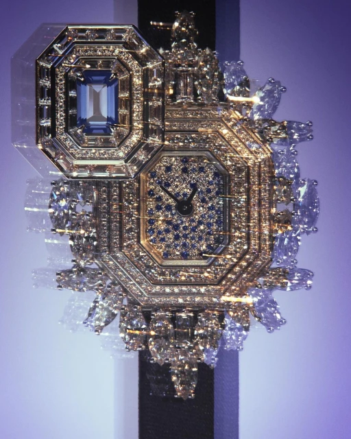 Luxury diamond watch on a black strap features an octagonal face encrusted with gems and gold, set against a gradient purple backdrop.
