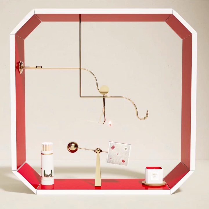 Abstract product display featuring cylindrical bottles, candle, and geometric shapes in a white and red frame against a neutral backdrop.