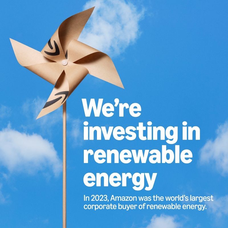 Pinwheel with the Amazon logo against a bright blue sky with soft clouds. Renewable energy concept image.