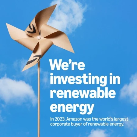 Pinwheel with the Amazon logo against a bright blue sky with soft clouds. Renewable energy concept image.