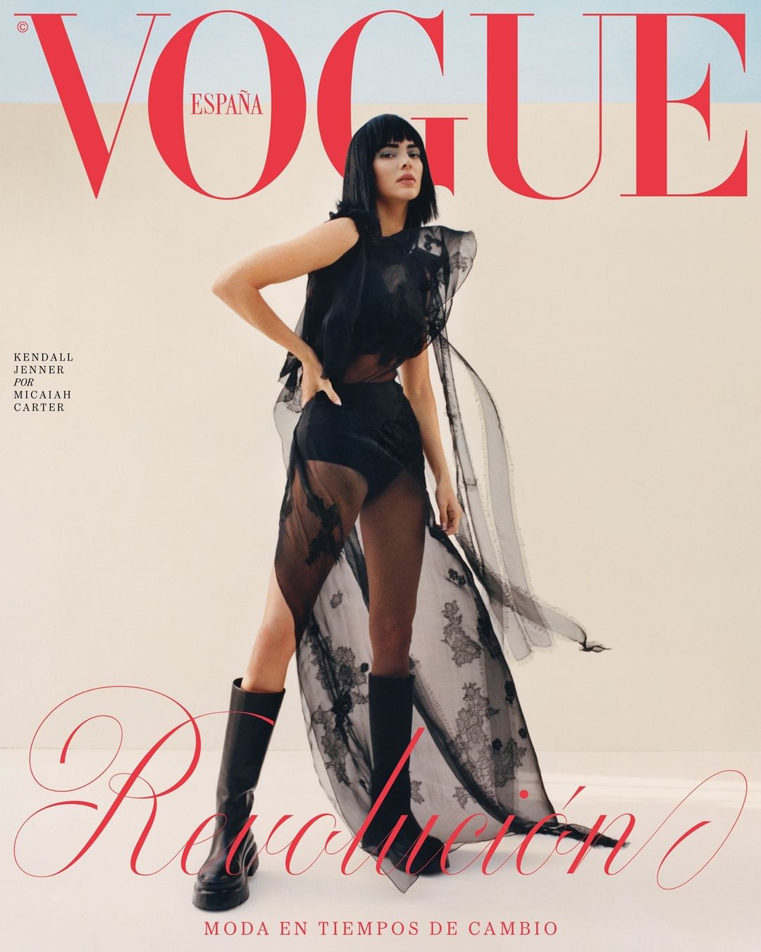 Vogue España cover featuring Kendall Jenner in black lace dress and boots, posing in a desert setting with red Vogue logo.