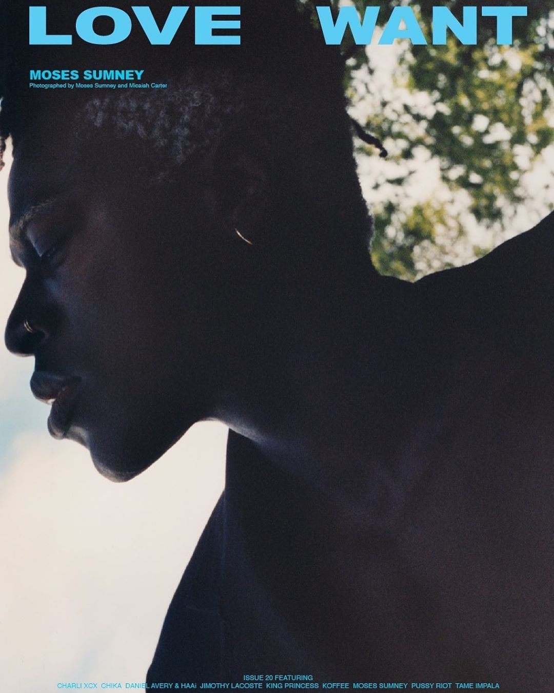 Close up of an African American male model with visible chest, dark lighting, and magazine text in the background. Fashion editorial.