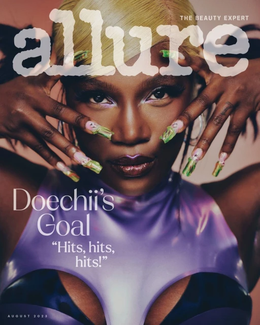 Close-up magazine cover featuring an adult Black female model with light blonde hair and long green nails, posing with hands framing the face.