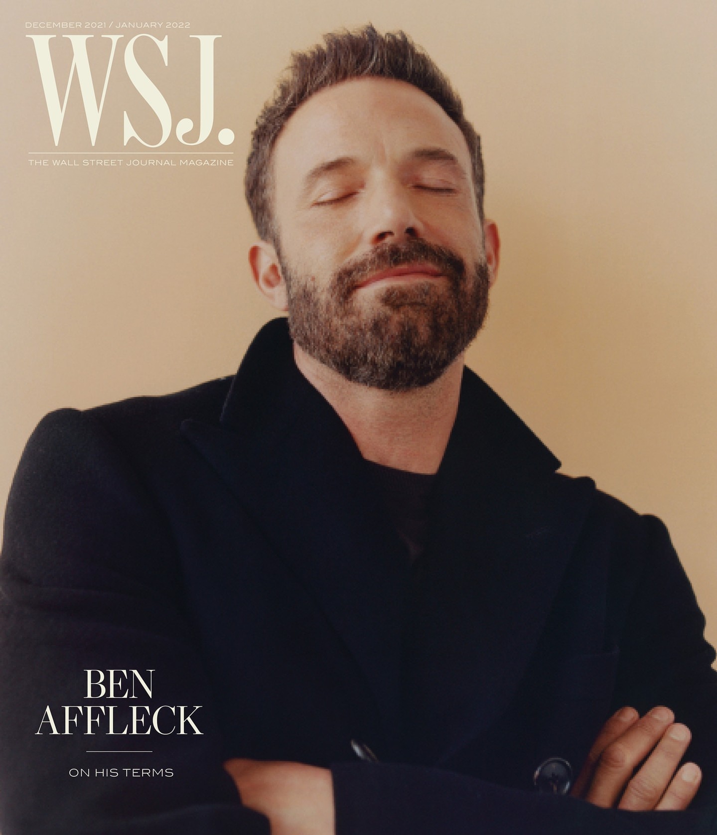 Close-up portrait of Ben Affleck on magazine cover, eyes closed, wearing black coat, with magazine text visible on tan background.