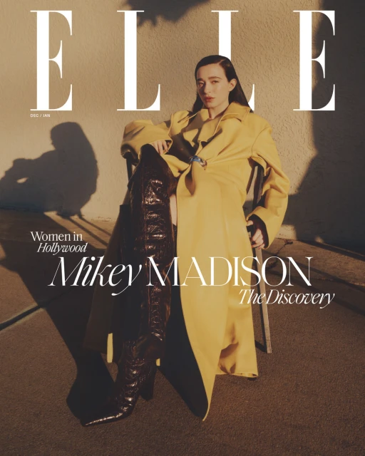 ELLE magazine cover featuring Mikey Madison in a yellow trench coat and high brown boots, posing outdoors with shadows and modern fonts.