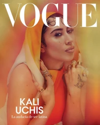 Kali Uchis wearing a yellow and orange hooded top and multiple rings, photographed by Micaiah Carter