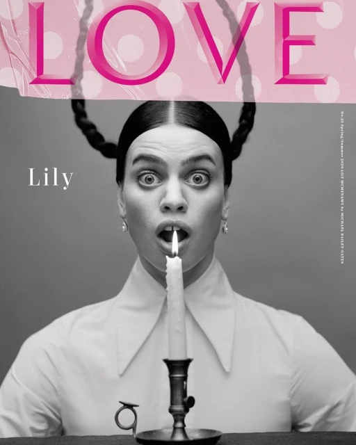 Black and white fashion magazine cover photo of a woman holding a lit candle in her mouth with the word LOVE printed above her head.