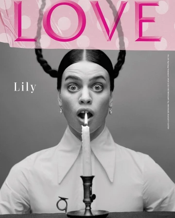Black and white fashion magazine cover photo of a woman holding a lit candle in her mouth with the word LOVE printed above her head.