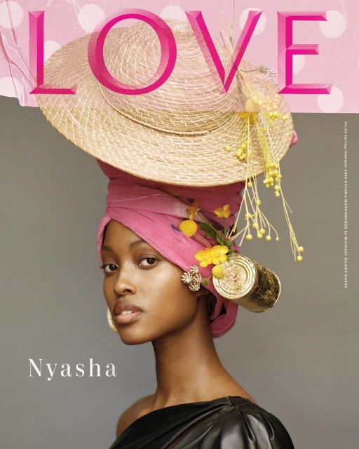 Stunning portrait of a woman wearing a pink headwrap and straw hat decorated with yellow flowers, showcasing beauty and fashion.