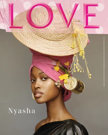 Stunning portrait of a woman wearing a pink headwrap and straw hat decorated with yellow flowers, showcasing beauty and fashion.