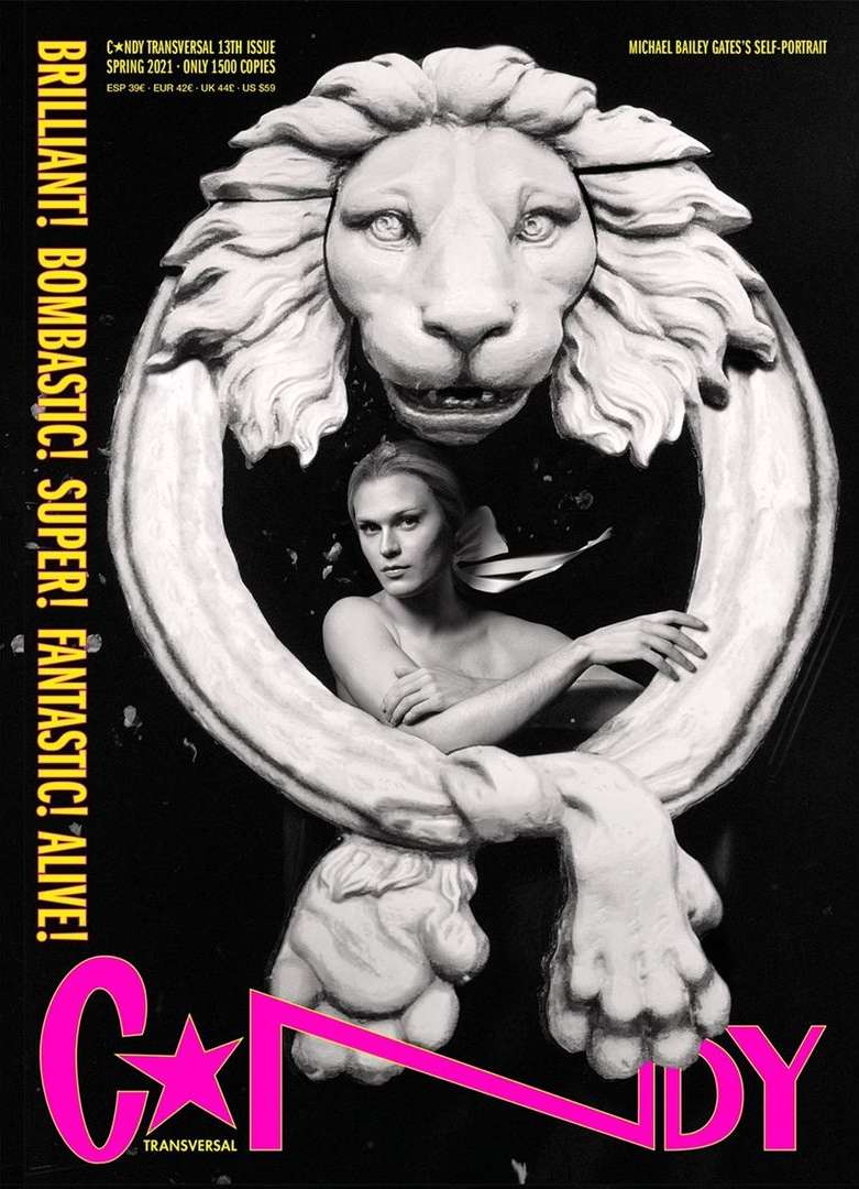 Black and white magazine cover featuring a woman in a sculpture, set against a dark background with pink text accents.