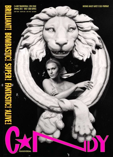 Black and white magazine cover featuring a woman in a sculpture, set against a dark background with pink text accents.