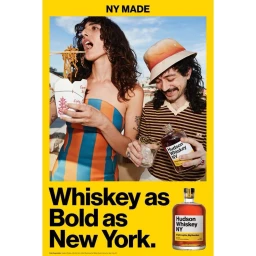 A woman eating noodles with chopsticks from a takeout box beside a man pouring whiskey into a glass from a bottle, outdoors.