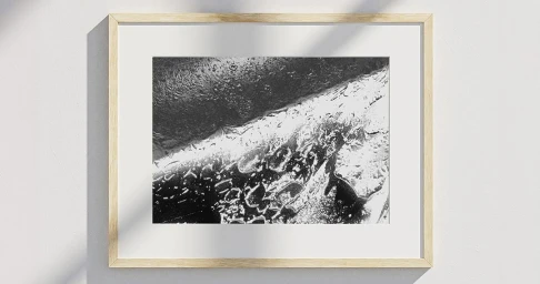 Framed black and white abstract macro photograph featuring textured liquid droplets on a dark surface