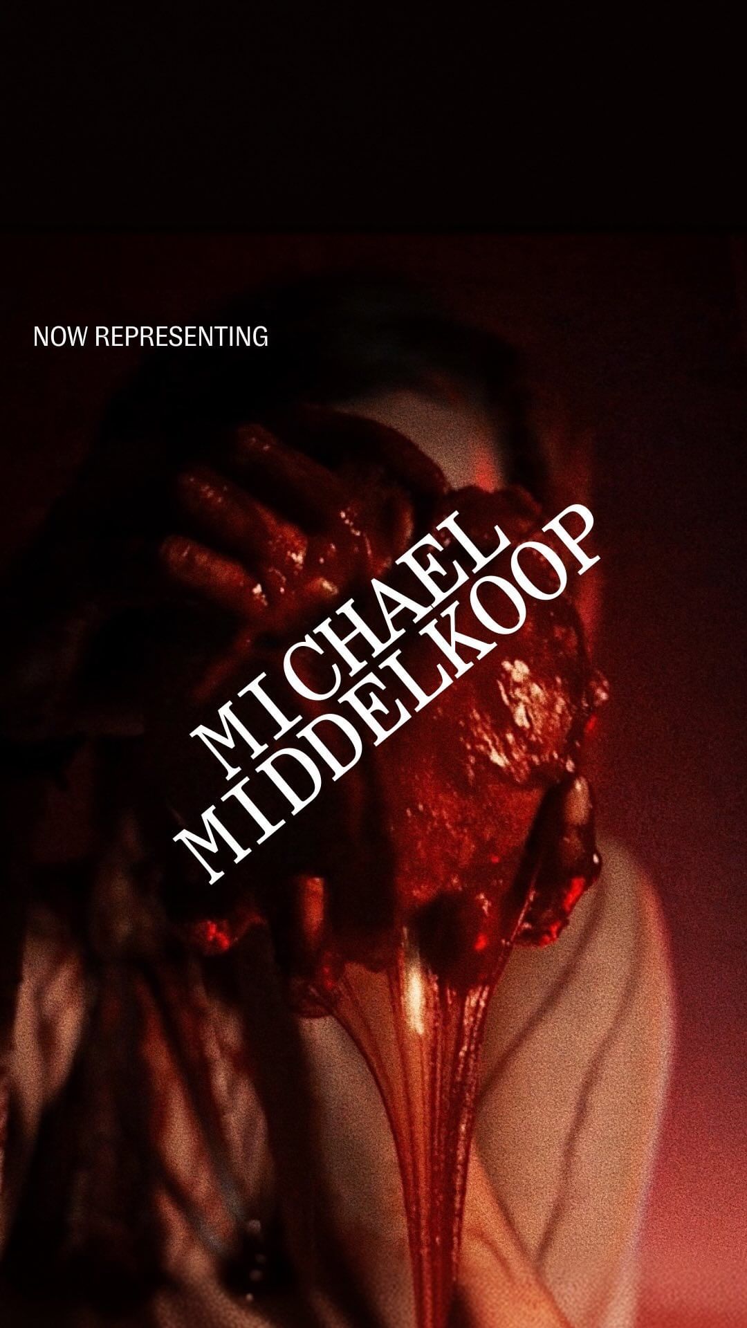 An adult clutches a faux heart spewing fake blood in a darkly lit scene, creating a dramatic visual effect. White text overlay.