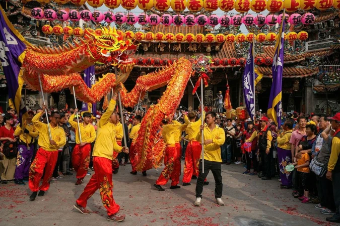 A dragon dance performance with a large crowd in front of a temple adorned with lanterns, showcasing a traditional cultural celebration.