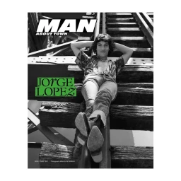Black and white portrait of a man reclining on railway tracks with arms behind his head, photographed by Miguel Reveriego.