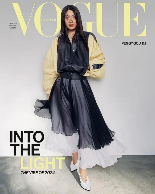 Vogue Deutsch cover featuring an Asian woman in a black and beige outfit, full body pose against a grey background, with 'Vogue' text overlay.