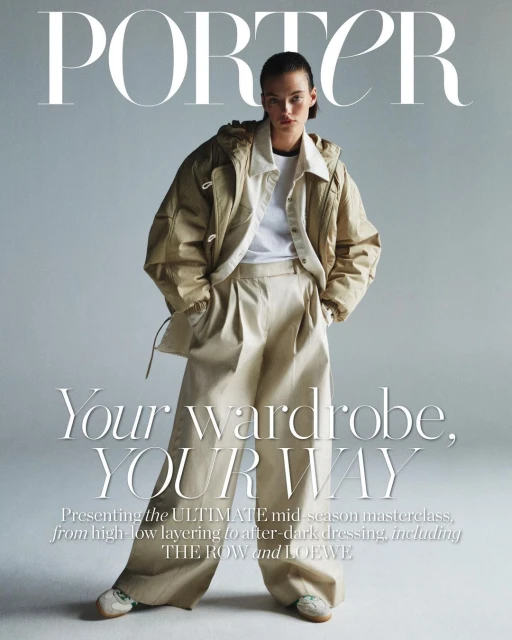 Fashion editorial cover for Porter magazine featuring a model in a tan jacket, white top, and wide-leg pants against a gray background.
