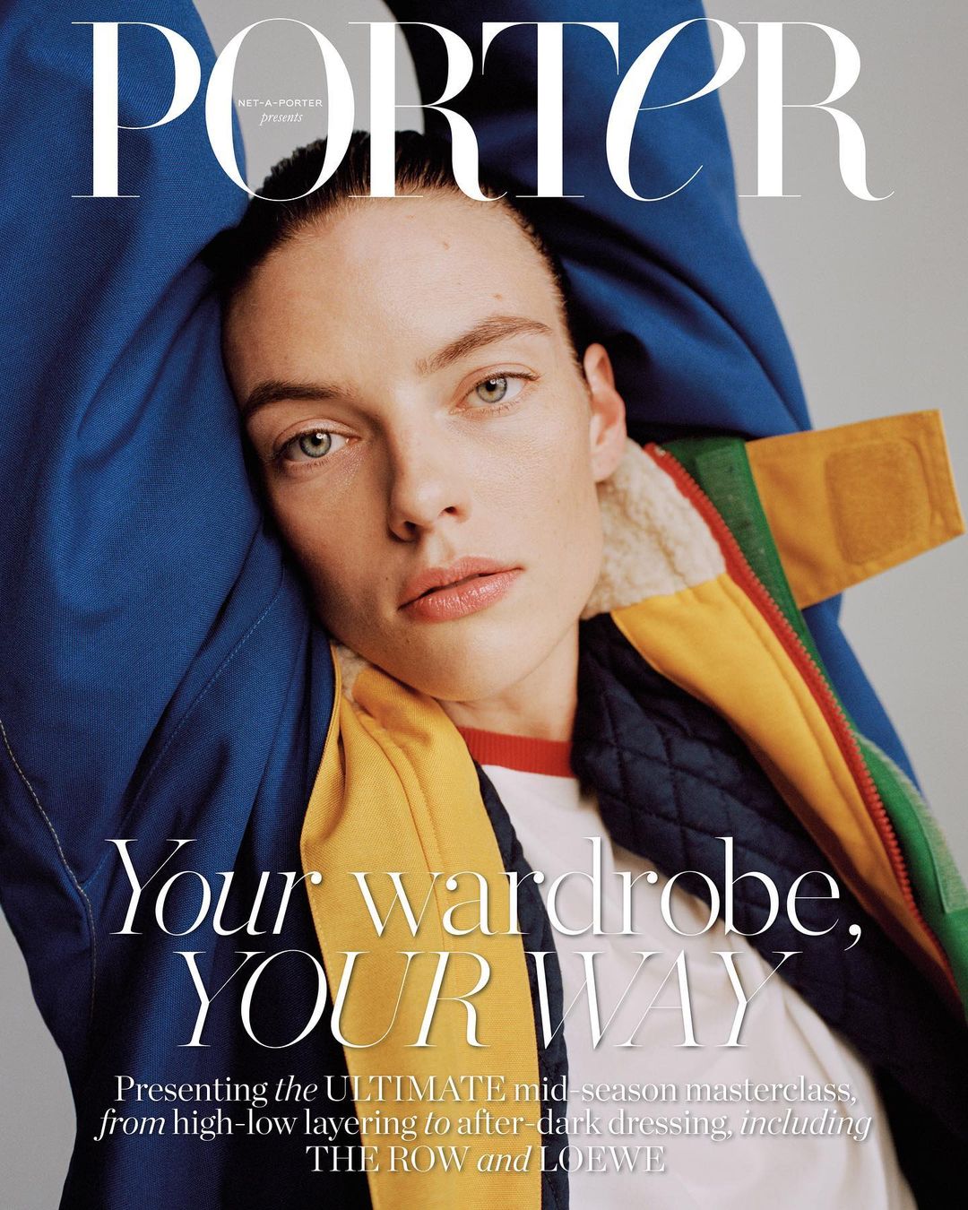 Magazine cover featuring a close-up of a woman with a bold blue jacket, a yellow accent, and the magazine title 'PORTER' in large white font.