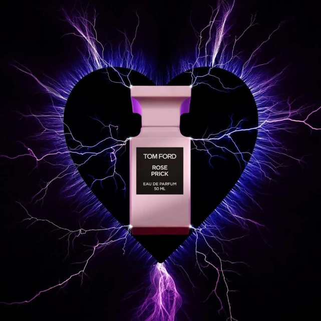 Close-up of Tom Ford Rose Prick perfume bottle, pink and black, with electrical discharge graphic and heart shape against a black background.