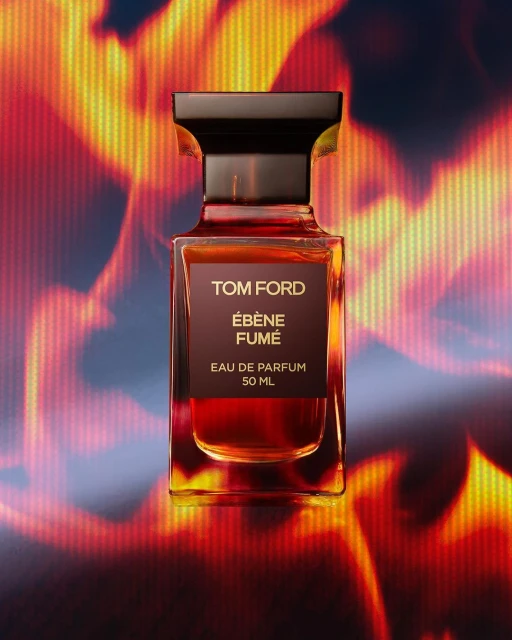 Tom Ford Ebène Fumé perfume bottle in a studio shot, featuring a blend of warm colors and clean lines against a fiery background.