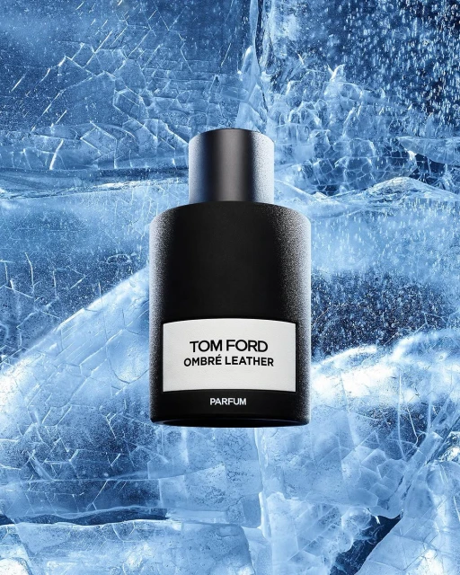 Tom Ford Ombré Leather Parfum bottle on textured ice surface, studio shot, cool blue tones, minimalist product photography, fragrance concept.