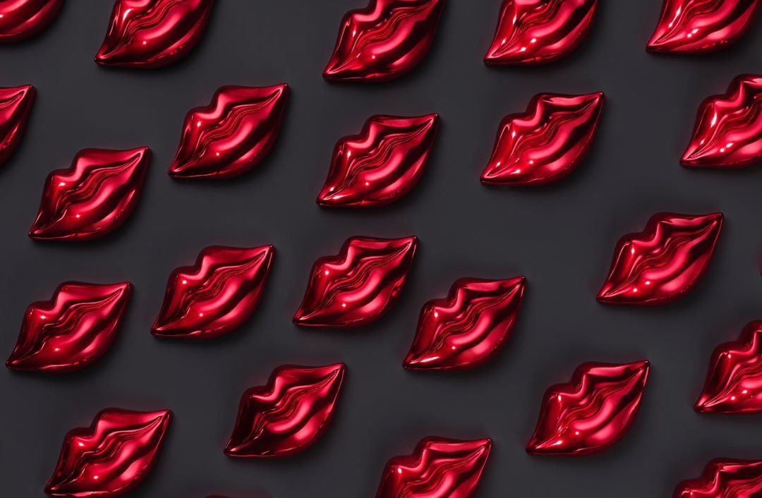 Red lips pattern on dark gray background. Repeating shiny, glossy lip shapes for beauty, fashion, or graphic design. Close-up, overhead.