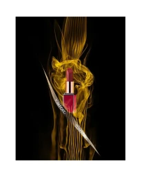 Tom Ford lipstick tube surrounded by swirling gold smoke against a solid black background by Mitchell Feinberg