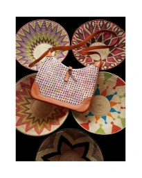 Woven hobo handbag with tan leather trim displayed against a background of five patterned round woven plates.