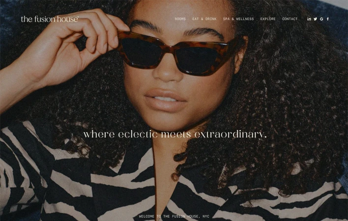 Woman with curly hair wearing tortoiseshell sunglasses and a zebra-print jacket in a website design layout for The Fusion House.