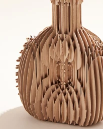 Close-up of a complex wooden laser-cut sculpture vase with intersecting ribs against a light background.