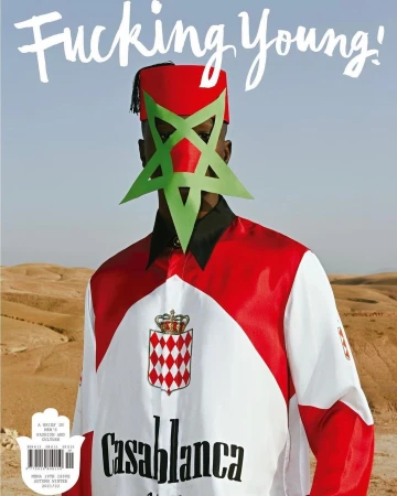 Magazine cover featuring a person wearing traditional Moroccan clothing and a geometric mask, set against a desert landscape.